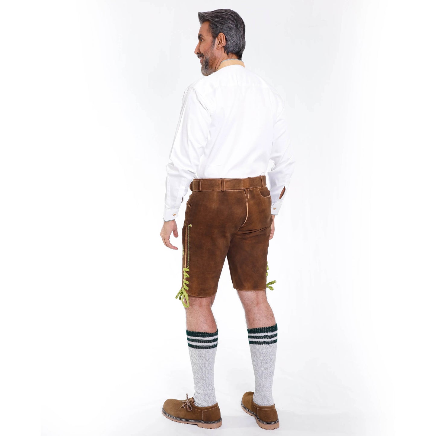 Brown suede lederhosen from side/back with green embroidery on hem and leg panels