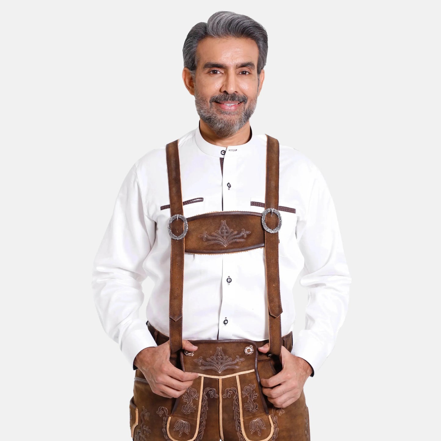 Brown leather suspenders worn with traditional trousers, oval ring clasps