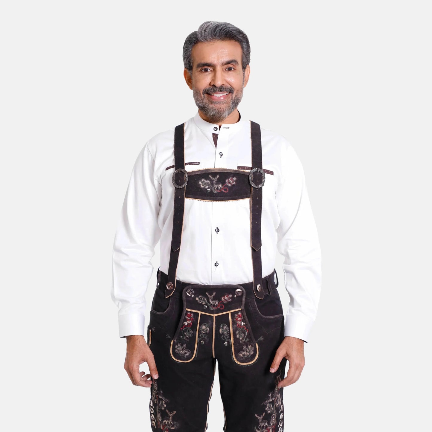 Black lederhosen suspenders worn with white shirt; floral embroidery and adjustable straps