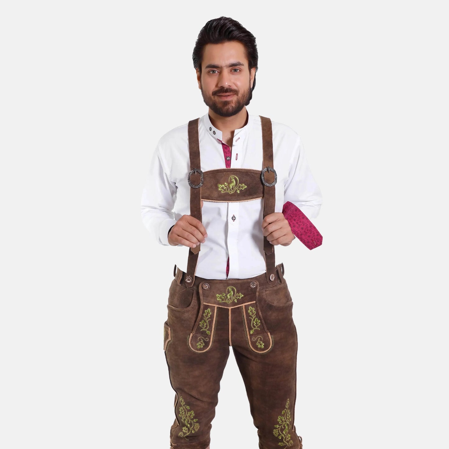 Brown leather suspenders with green embroidery over brown pants, adjustable straps