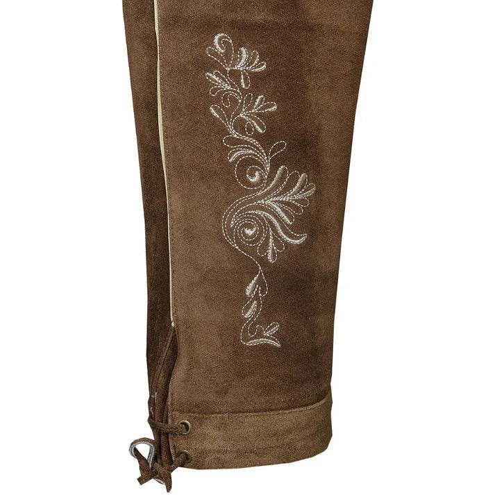 Brown suede lederhosen leg close-up with ornate embroidery and drawstring hem