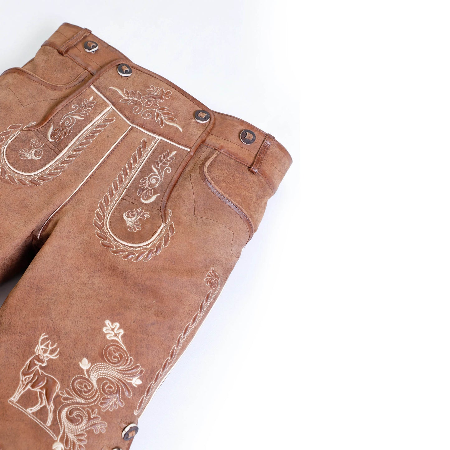 Brown lederhosen waistband close-up with metal buttons and embroidered chest motif