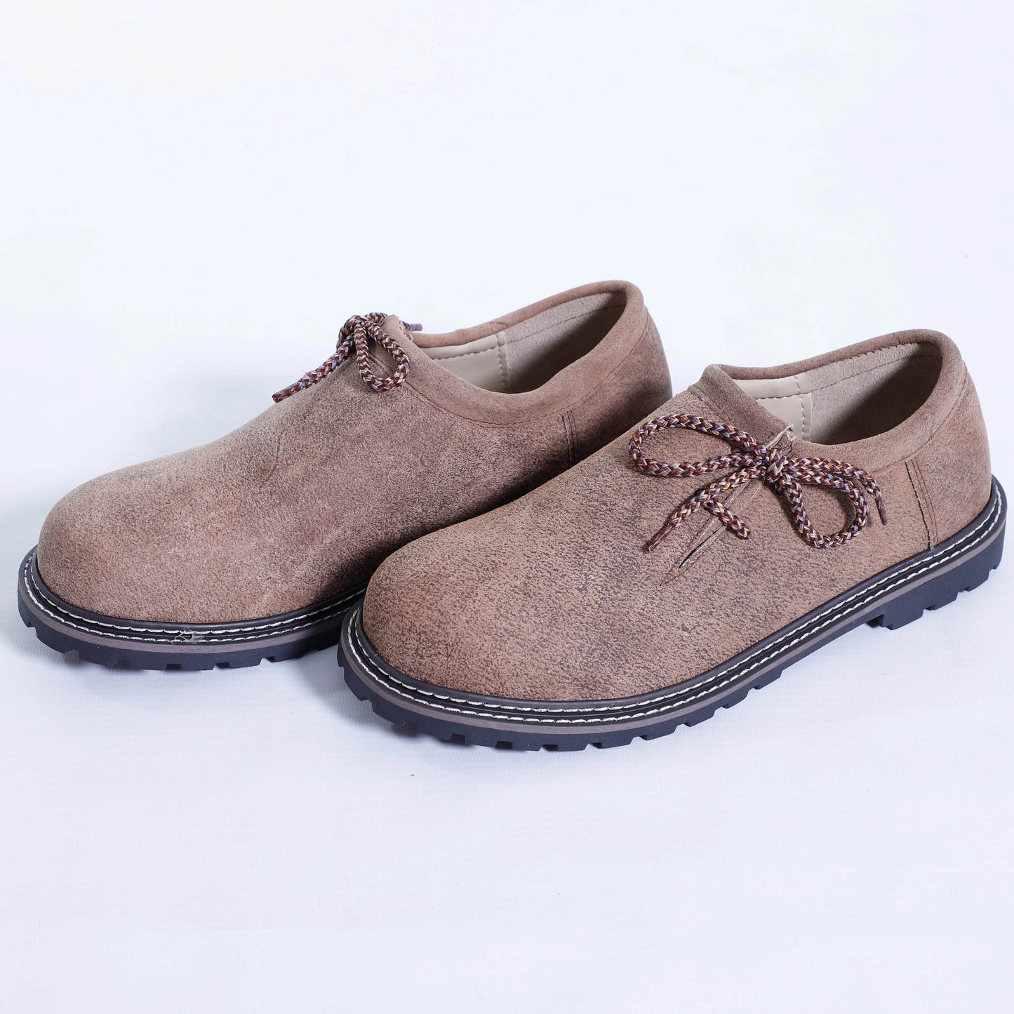 Men's taupe suede slip-on shoes with braided bow laces and dark rubber soles
