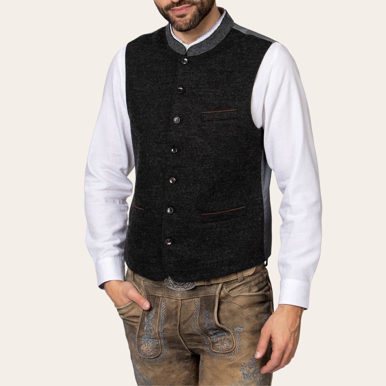 Charcoal vest worn over white shirt; button front with contrast-trim chest pocket