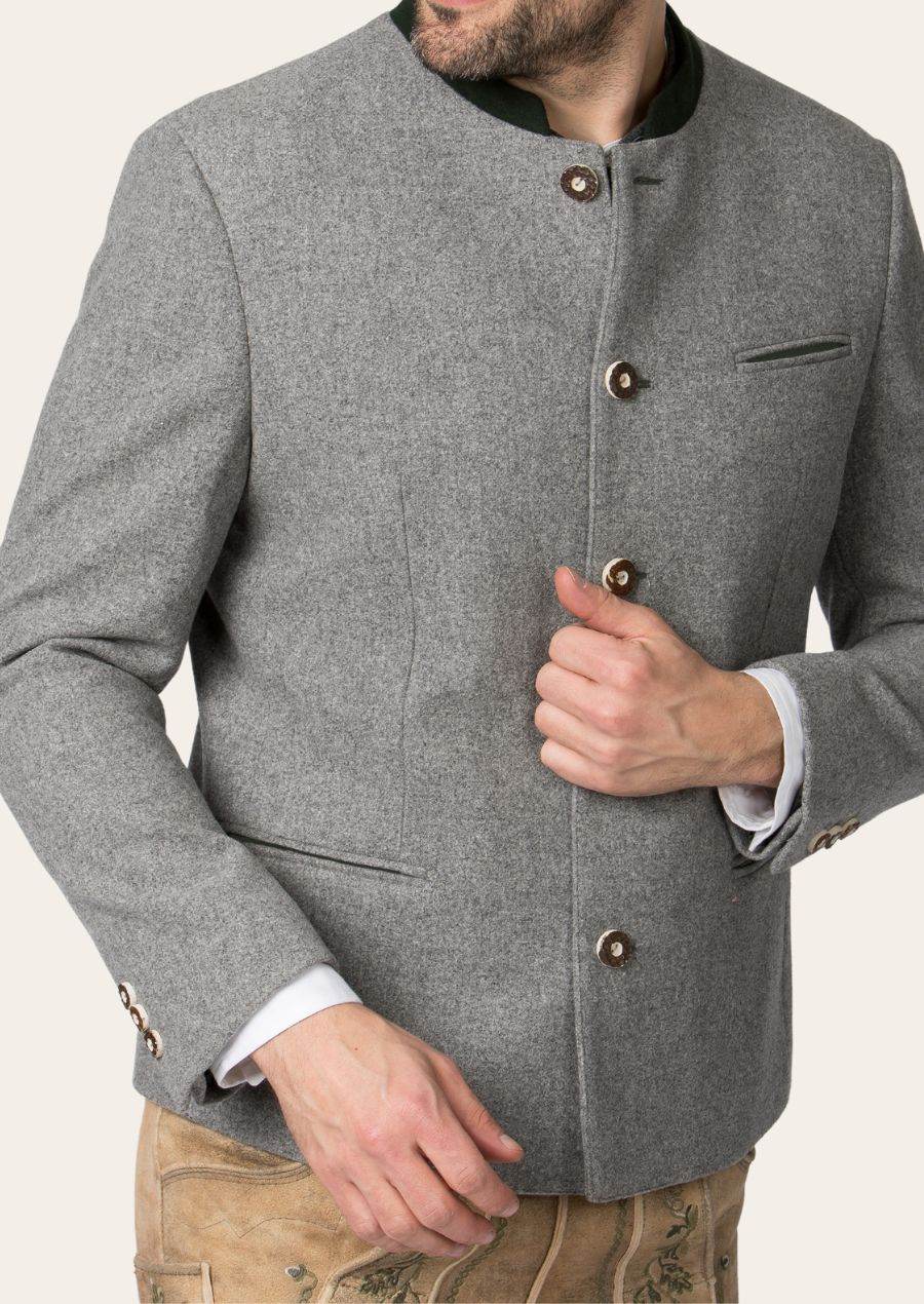 Gray trachten jacket close-up with green stand collar, horn buttons, and chest pocket