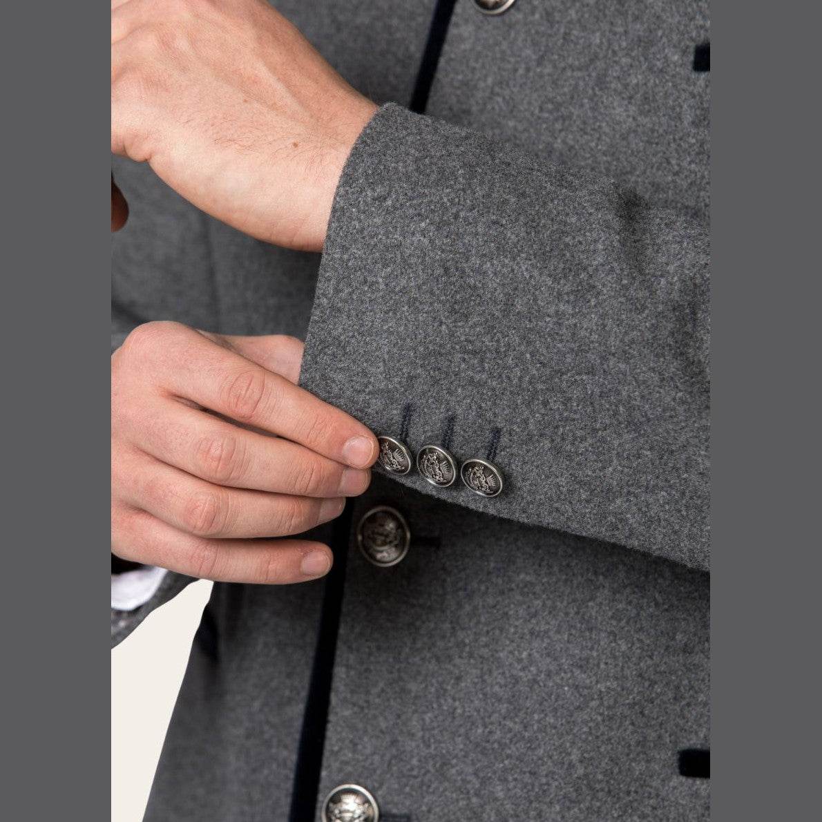 Close-up of mens jacket front with metal buttons and black trim on placket