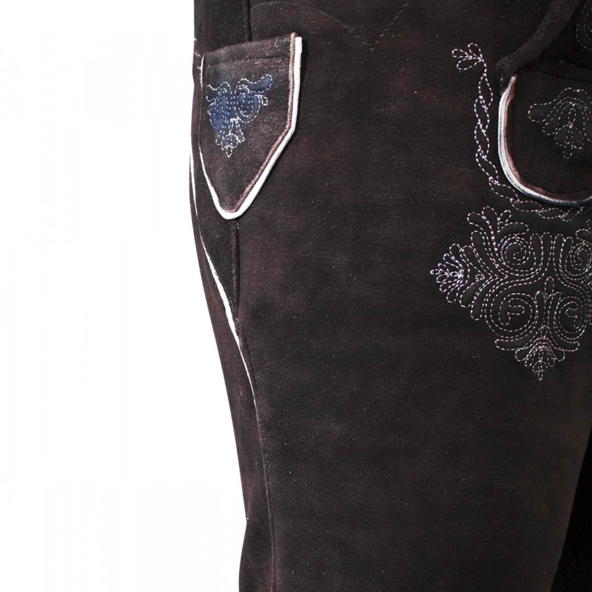 Close-up of brown suede lederhosen with white piping and blue embroidered motifs
