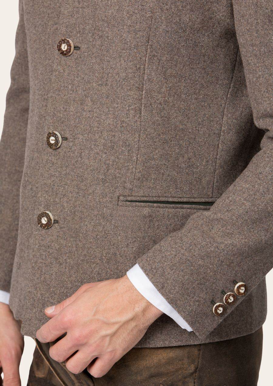 Men's janker jacket detail: stand collar, horn-style buttons, and welt pocket flap