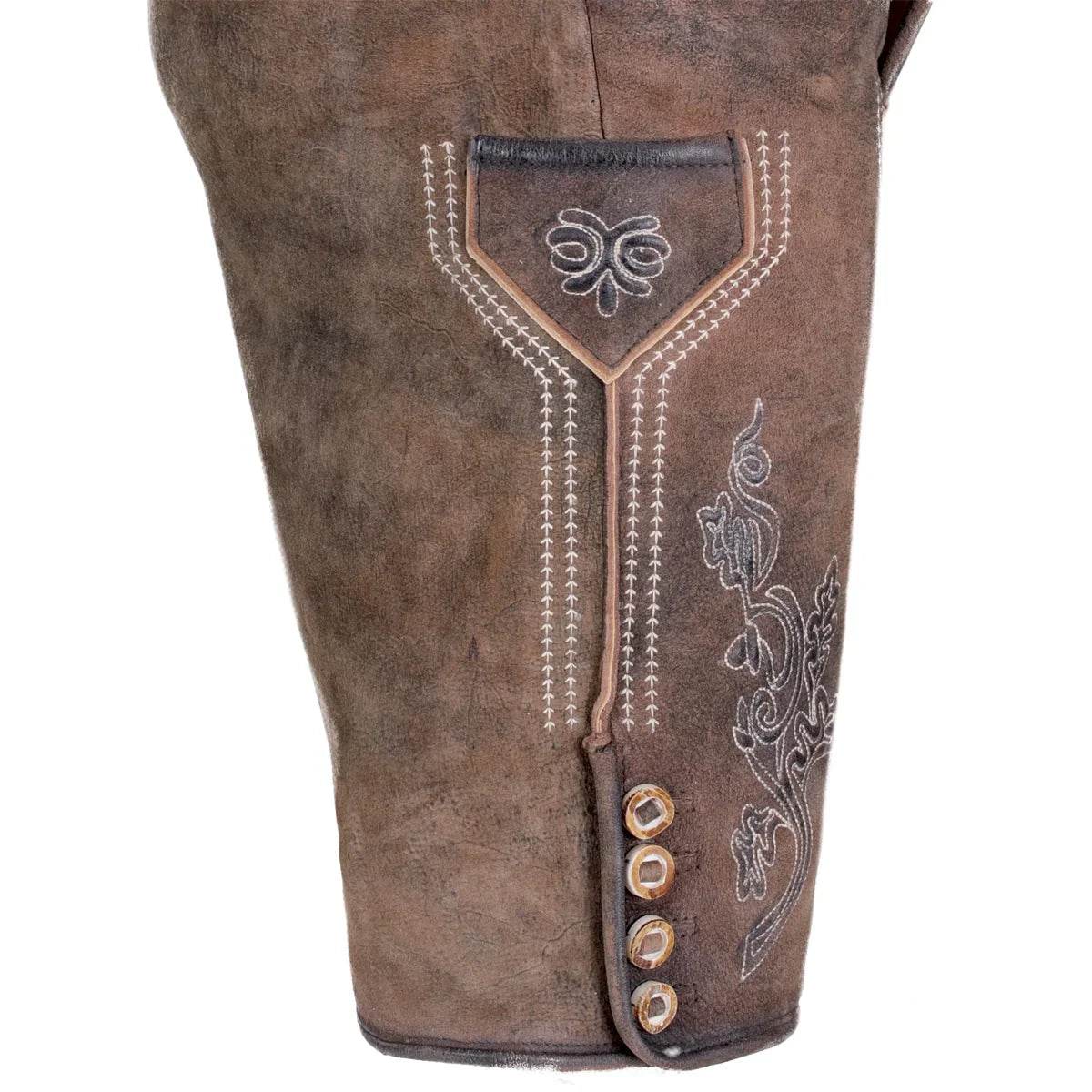 Brown leather lederhosen close-up with stitched pocket panel and metal button trim