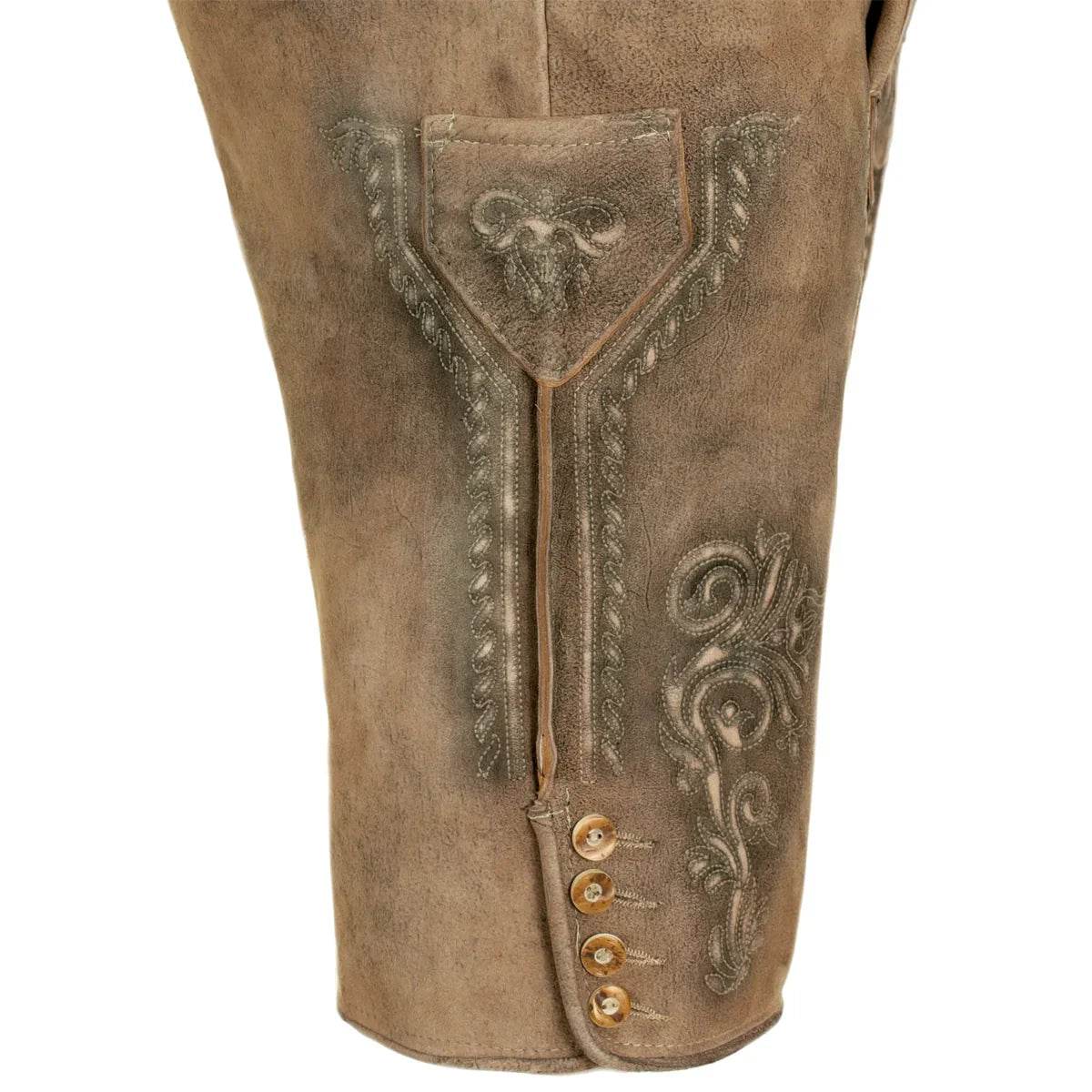 Close-up of light brown lederhosen with ornate front panel and buttoned fly