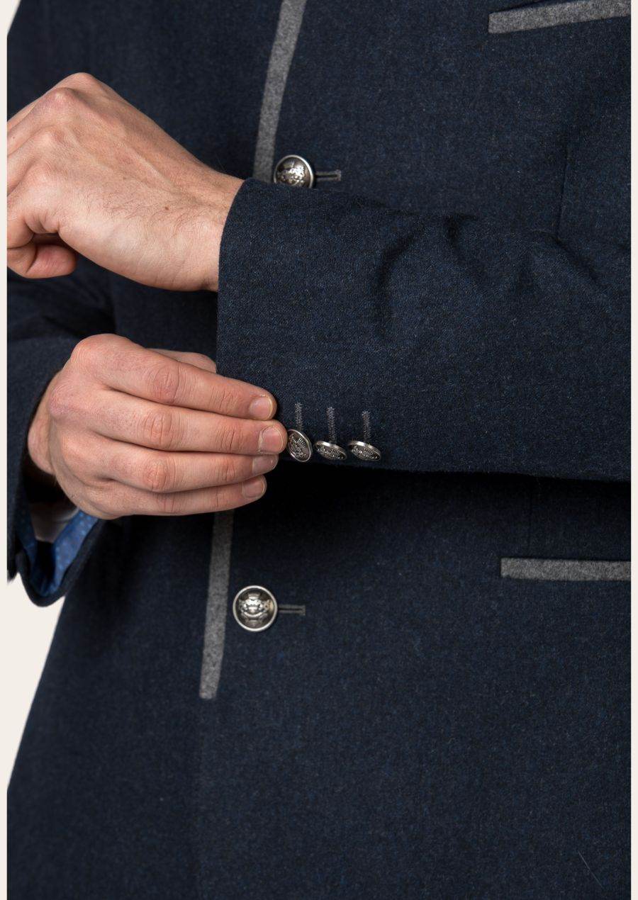 Dark navy jacket cuff detail with silver buttons and stitched emblem