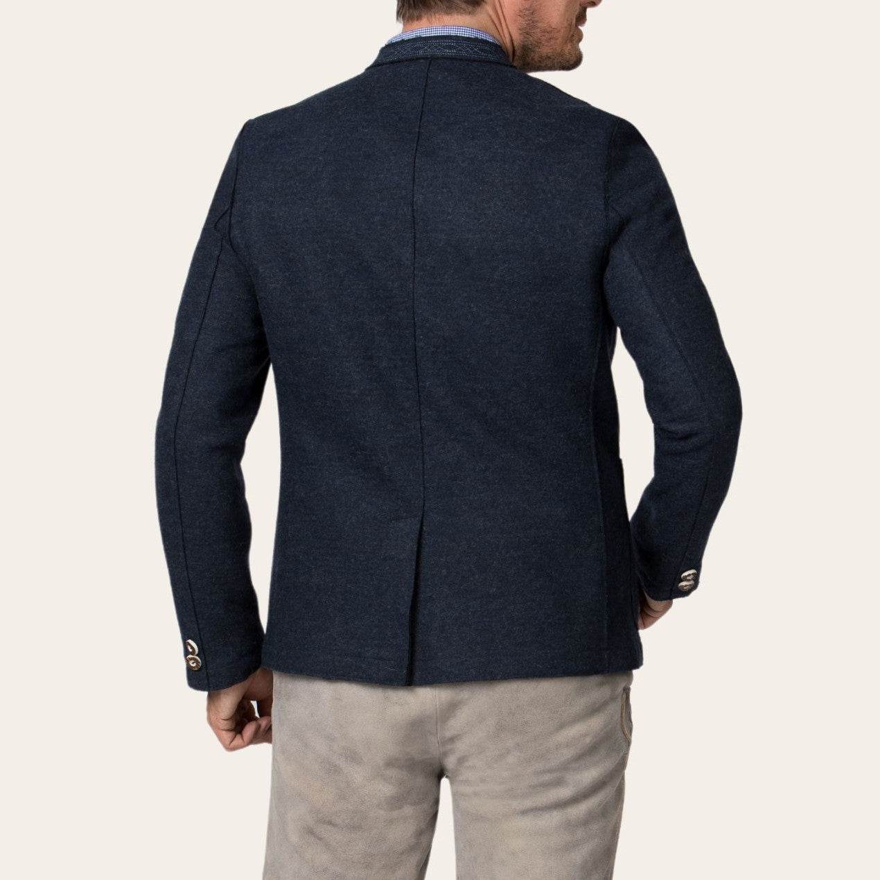 Men's dark blue jacket back view with center seam and long sleeves