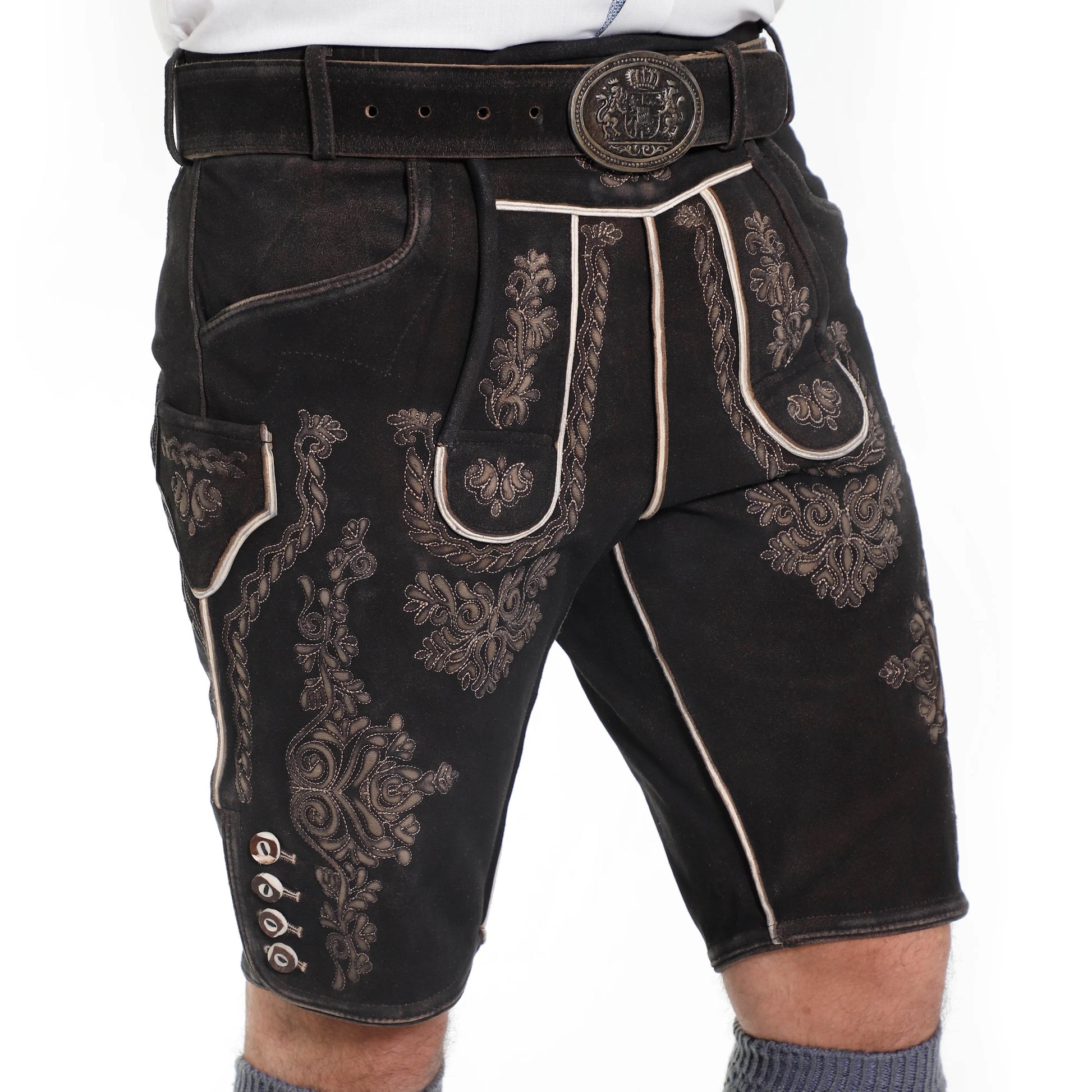 Men's dark suede lederhosen shorts with ornate side embroidery and contrast piping.