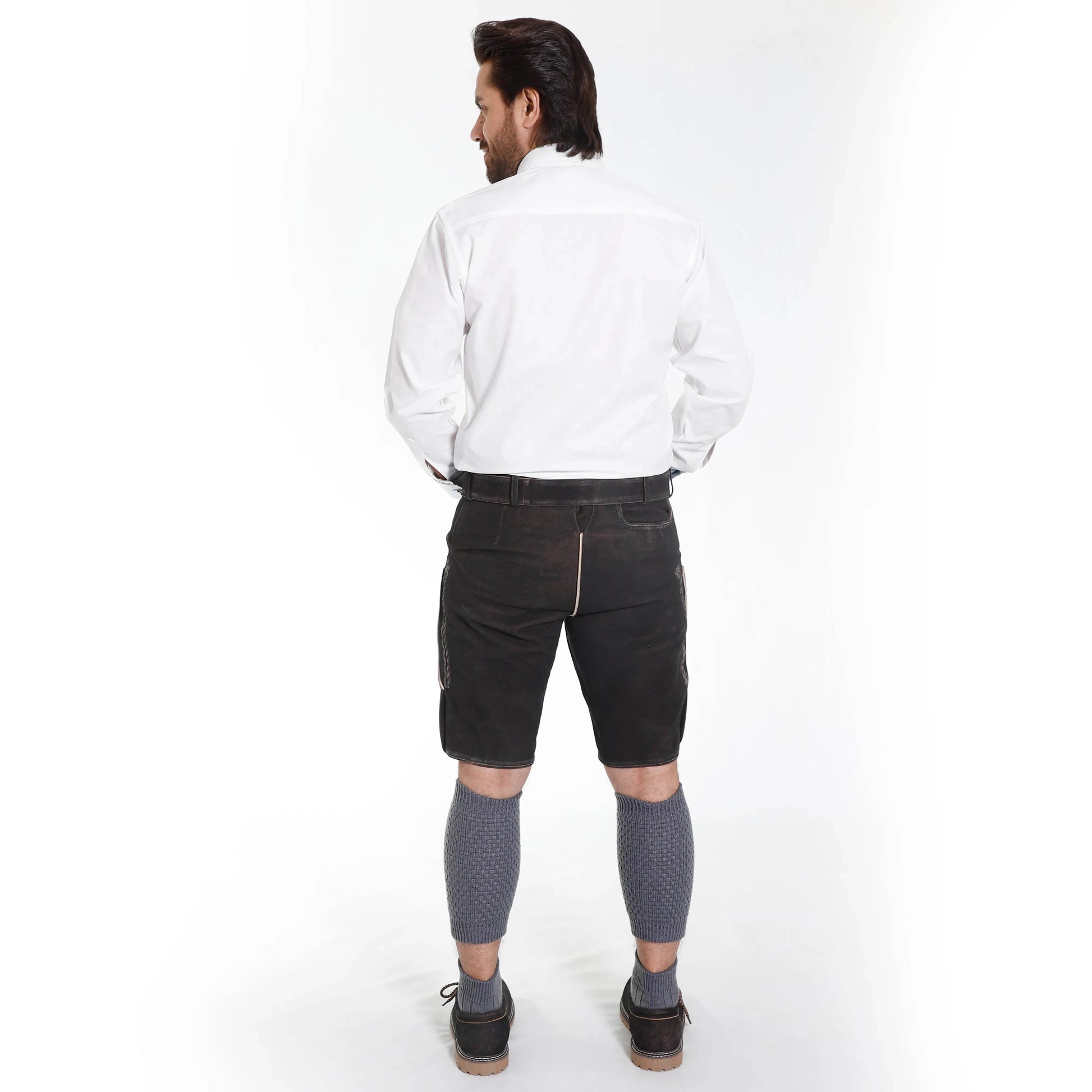 Men's dark suede lederhosen shorts, rear view with belt and decorative leg panels.