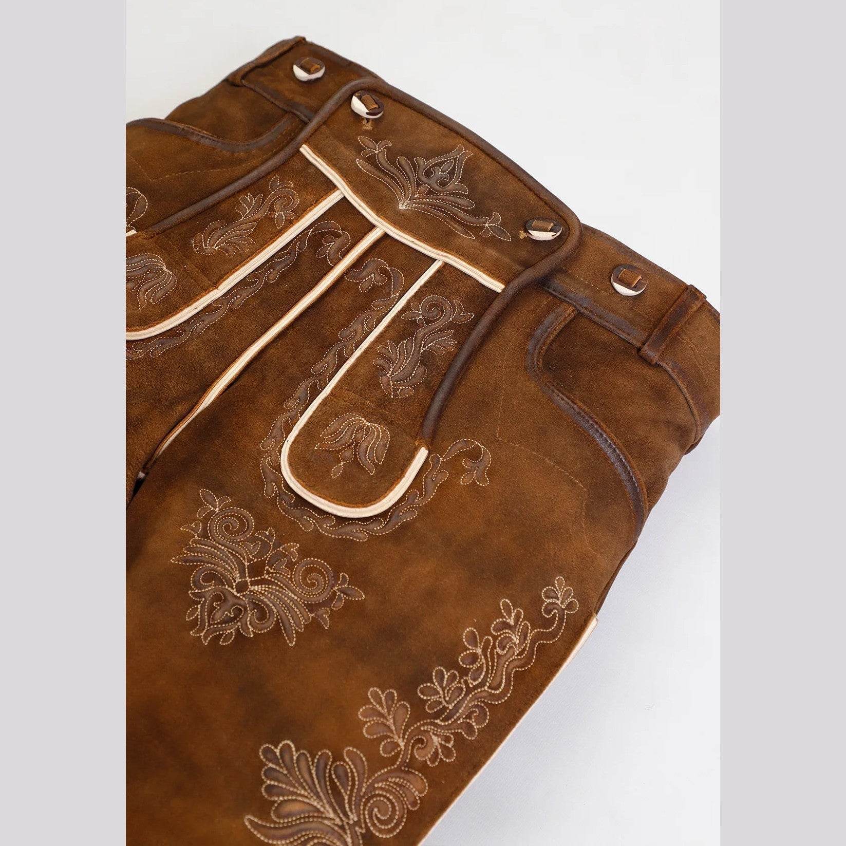 Brown short leather lederhosen detail with decorative trim, pocket flaps, and button tabs