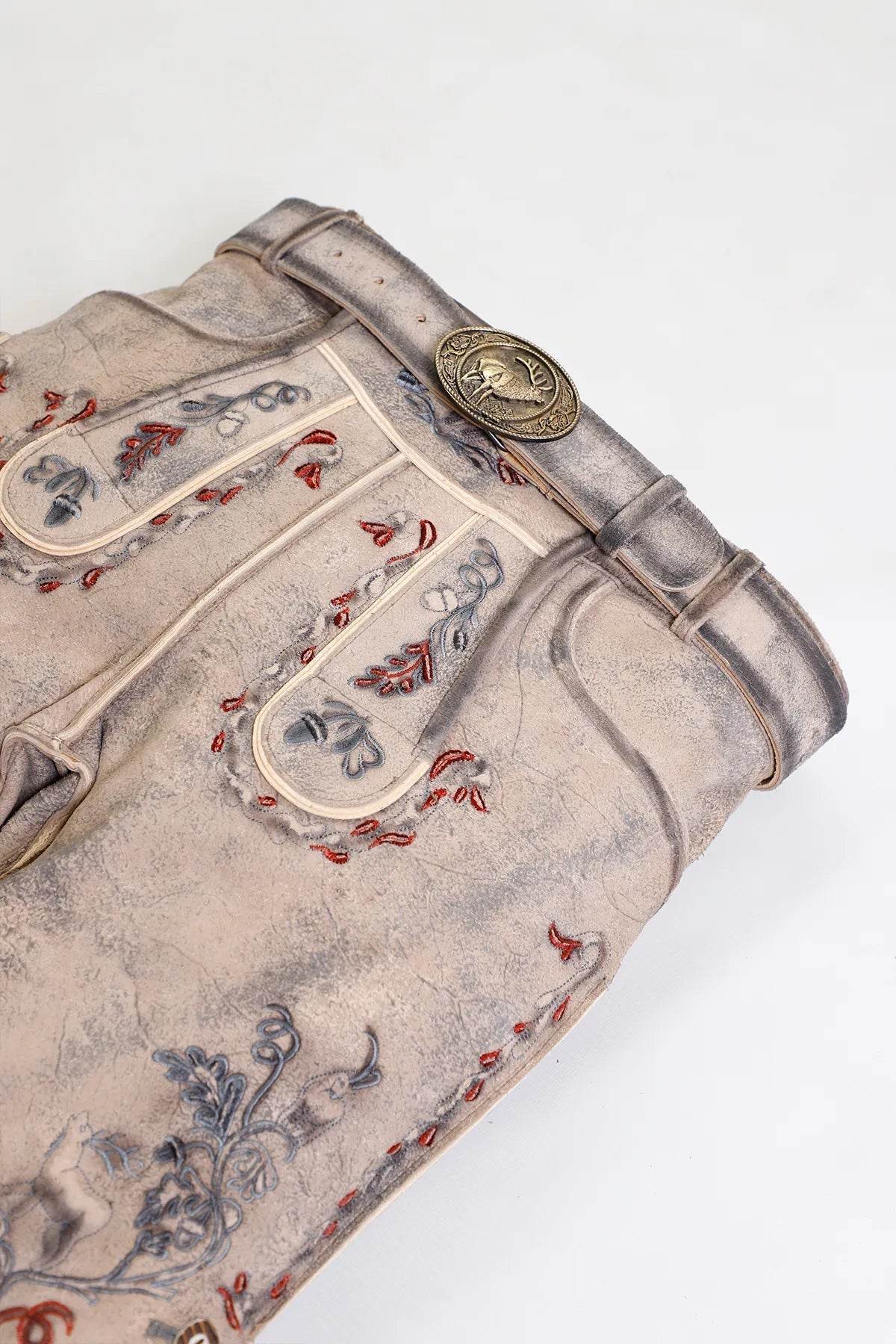 Mens short leather lederhosen fabric close-up, light gray with colorful decorative embroidery