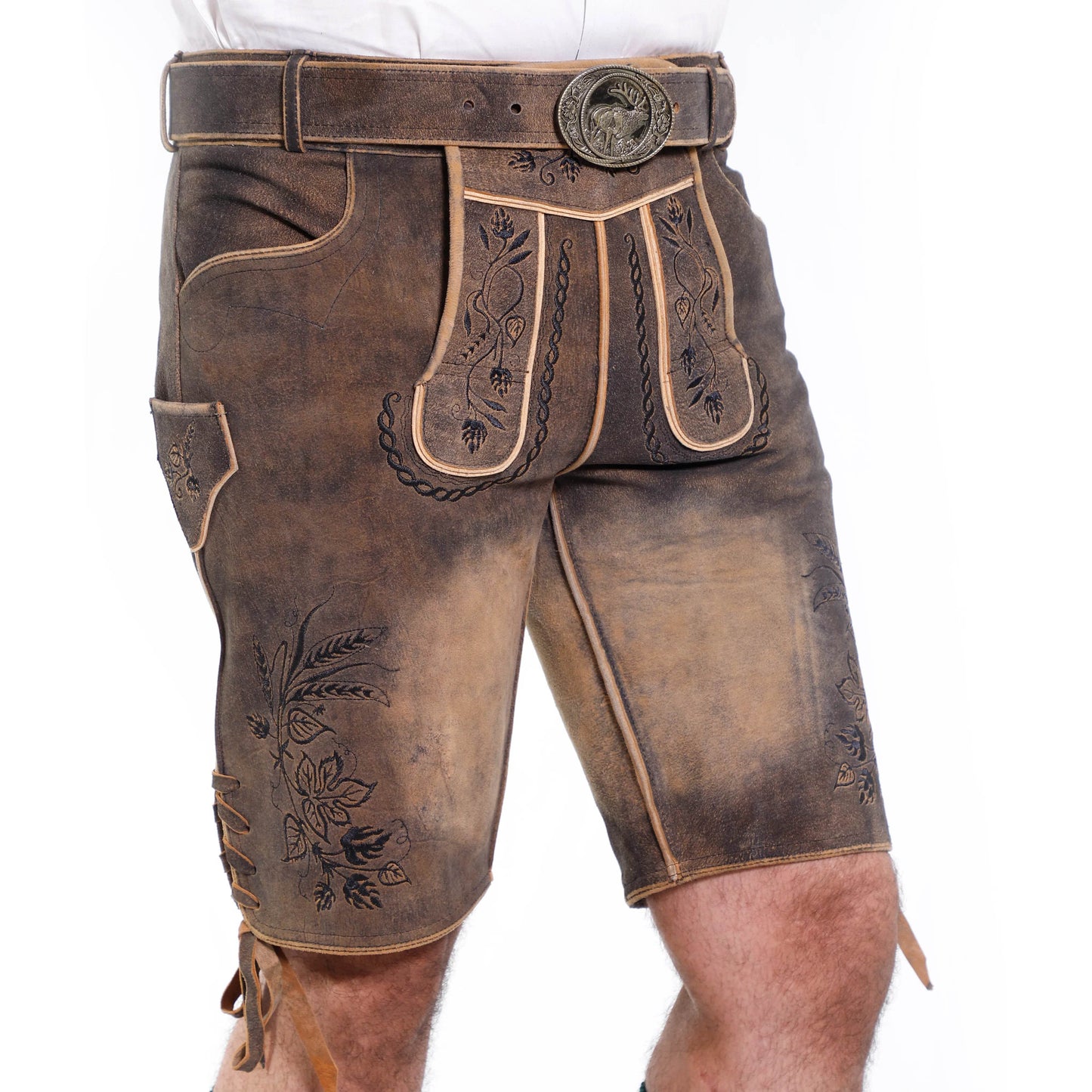 Close-up of brown short leather lederhosen with embroidery, belt buckle, and pocket detail