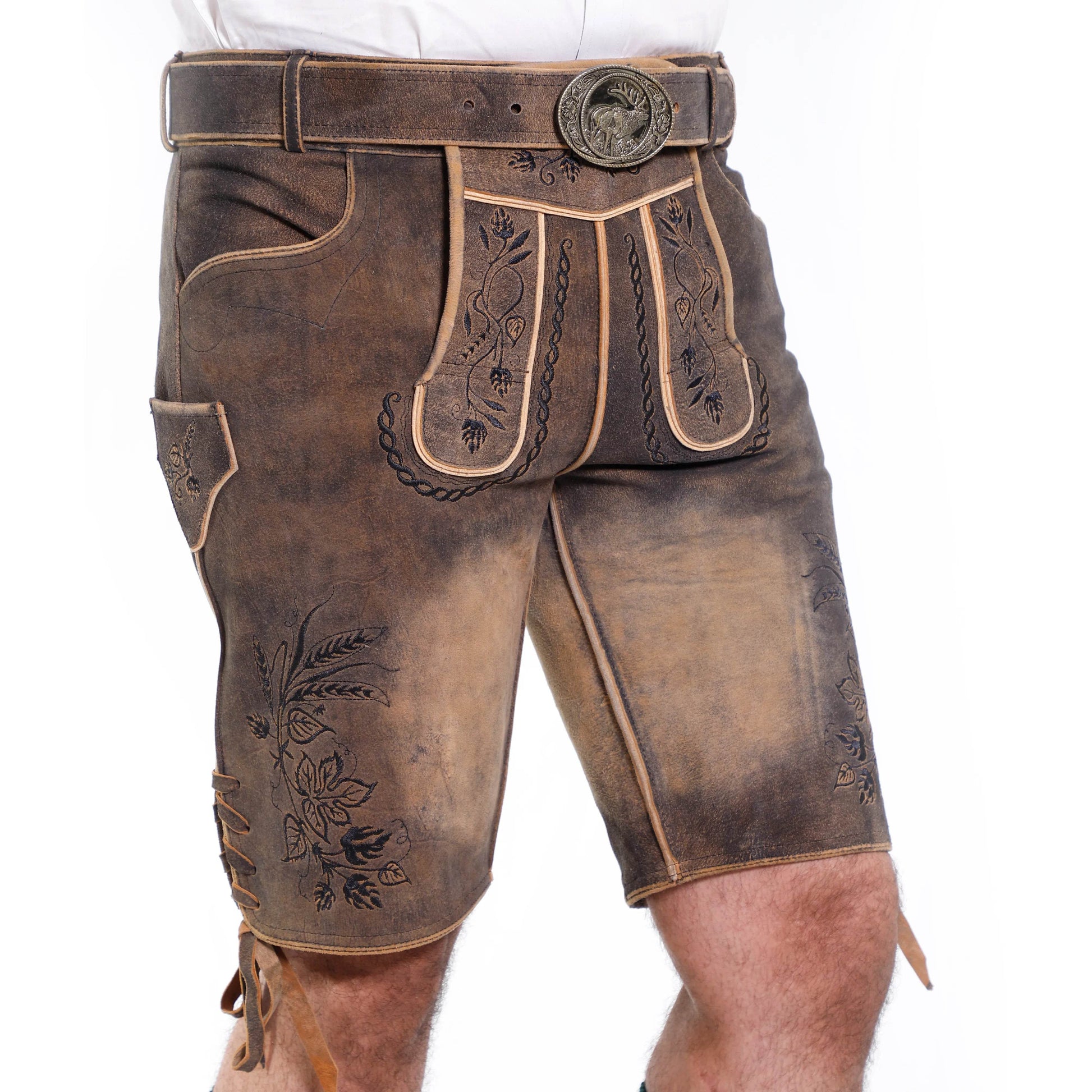 Close-up of brown short leather lederhosen with embroidery, belt buckle, and pocket detail