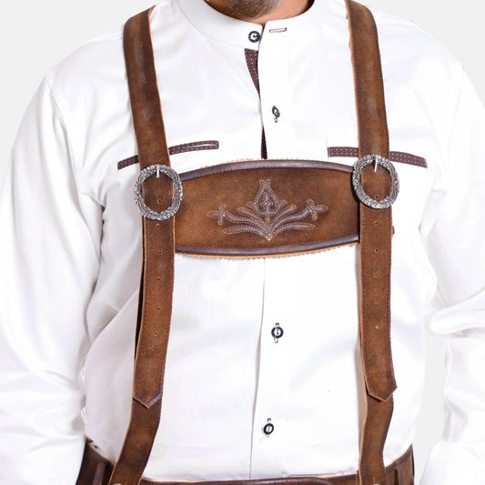 Brown leather suspenders worn over a white shirt, embossed front panel and oval rings