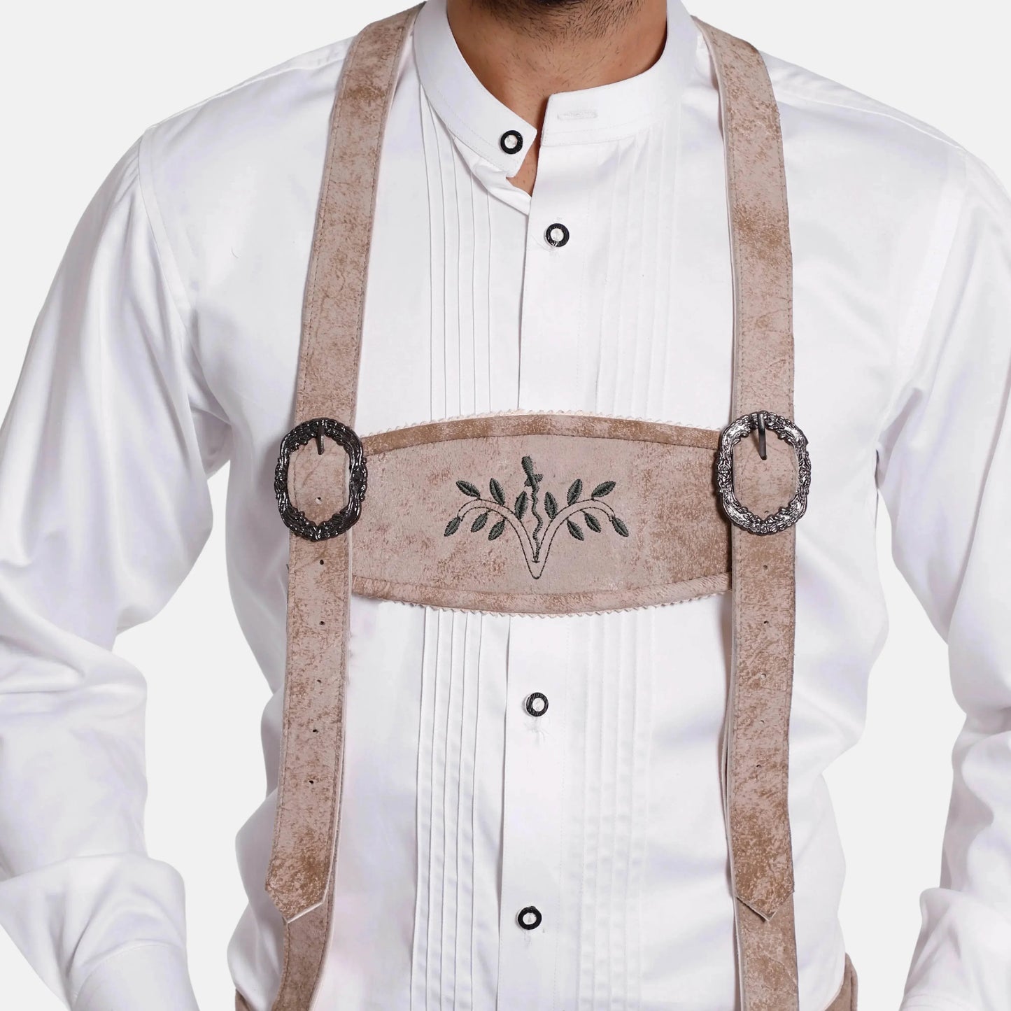 Leather suspenders worn over white shirt, with embroidered centerpiece and metal rings