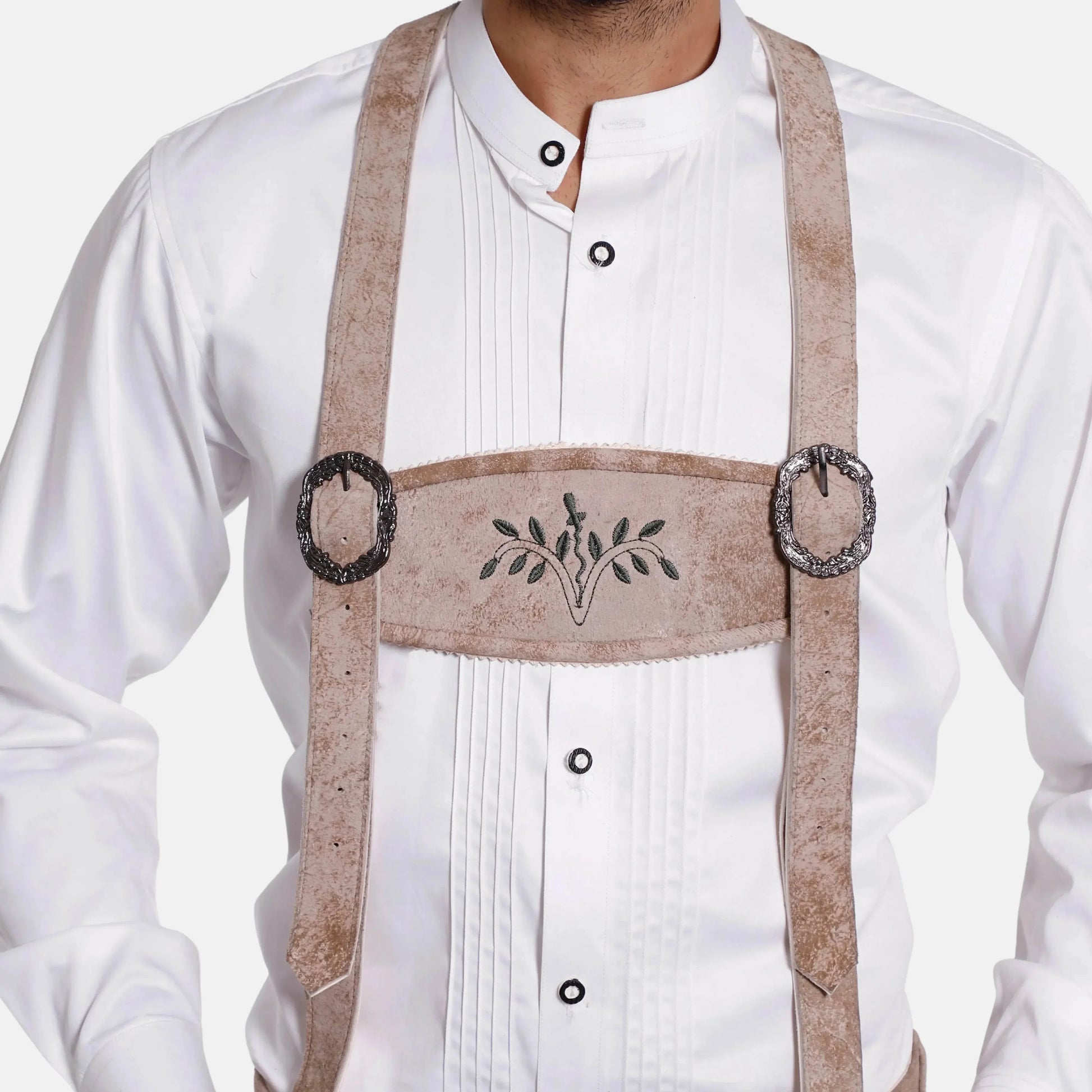 Leather suspenders worn over white shirt, with embroidered centerpiece and metal rings