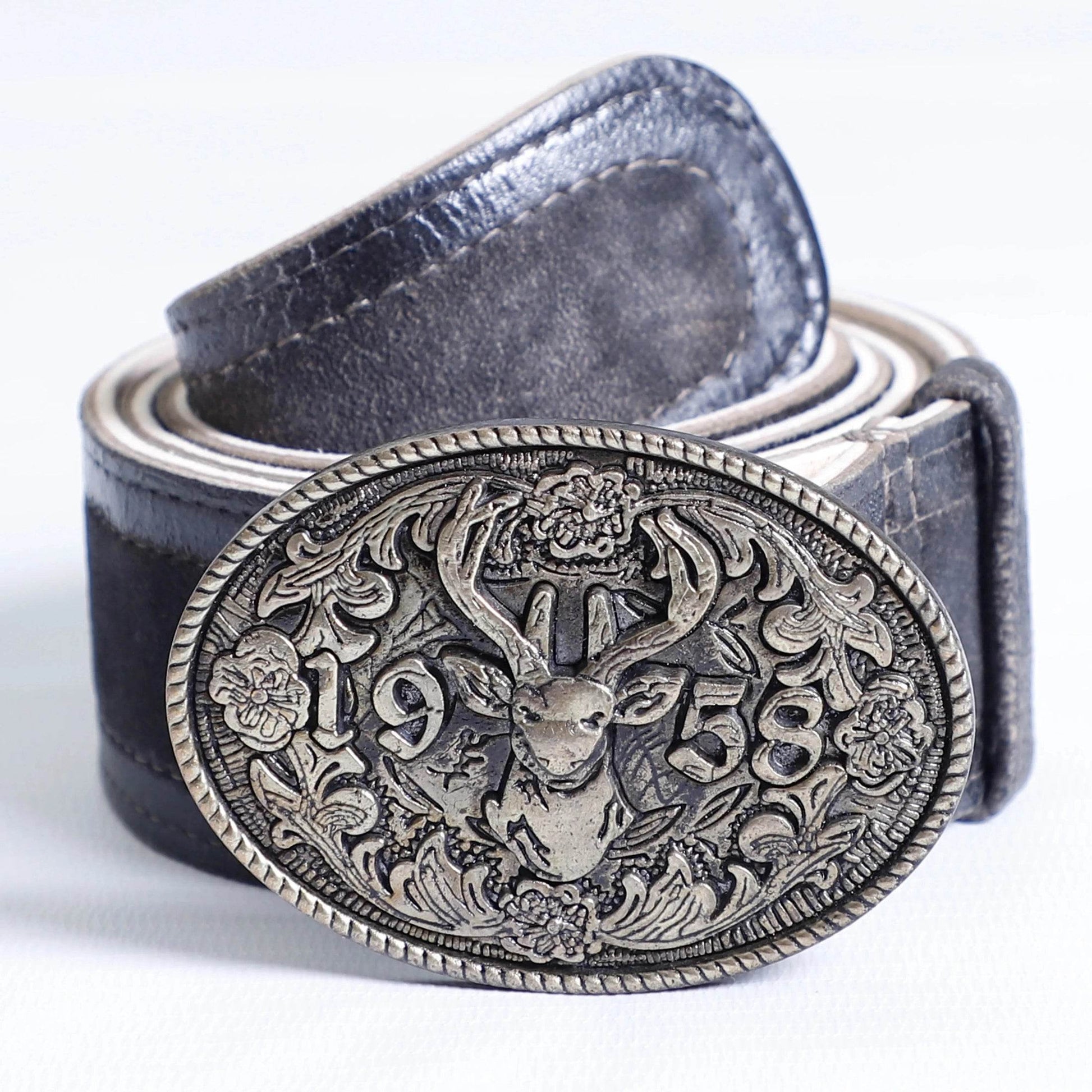 Men's dark leather belt close-up with ornate oval buckle featuring stag