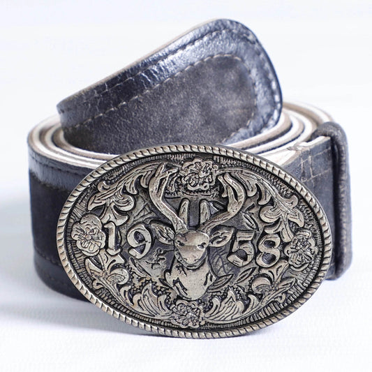 Men's dark leather belt close-up with ornate oval buckle featuring stag