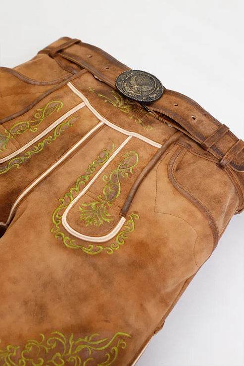Men's leather lederhosen waistband detail with oval buckle and green embroidery