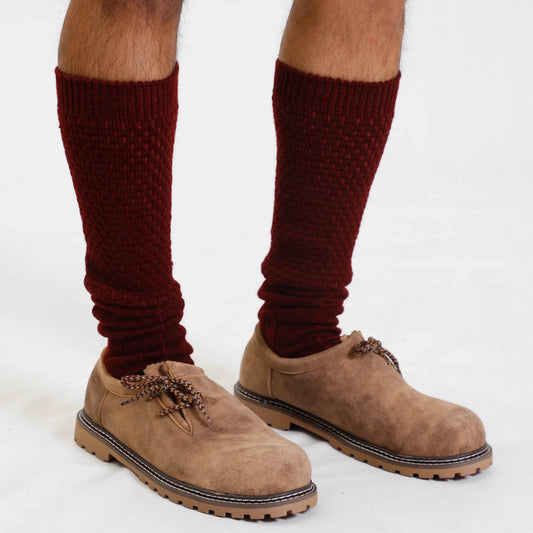 Knee-high traditional socks on legs with lace-up boots, burgundy knit
