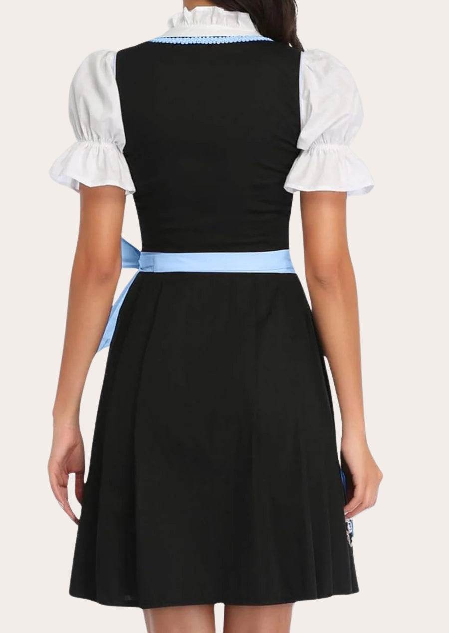 Dirndl dress back view: black bodice and full black skirt with light-blue waist trim